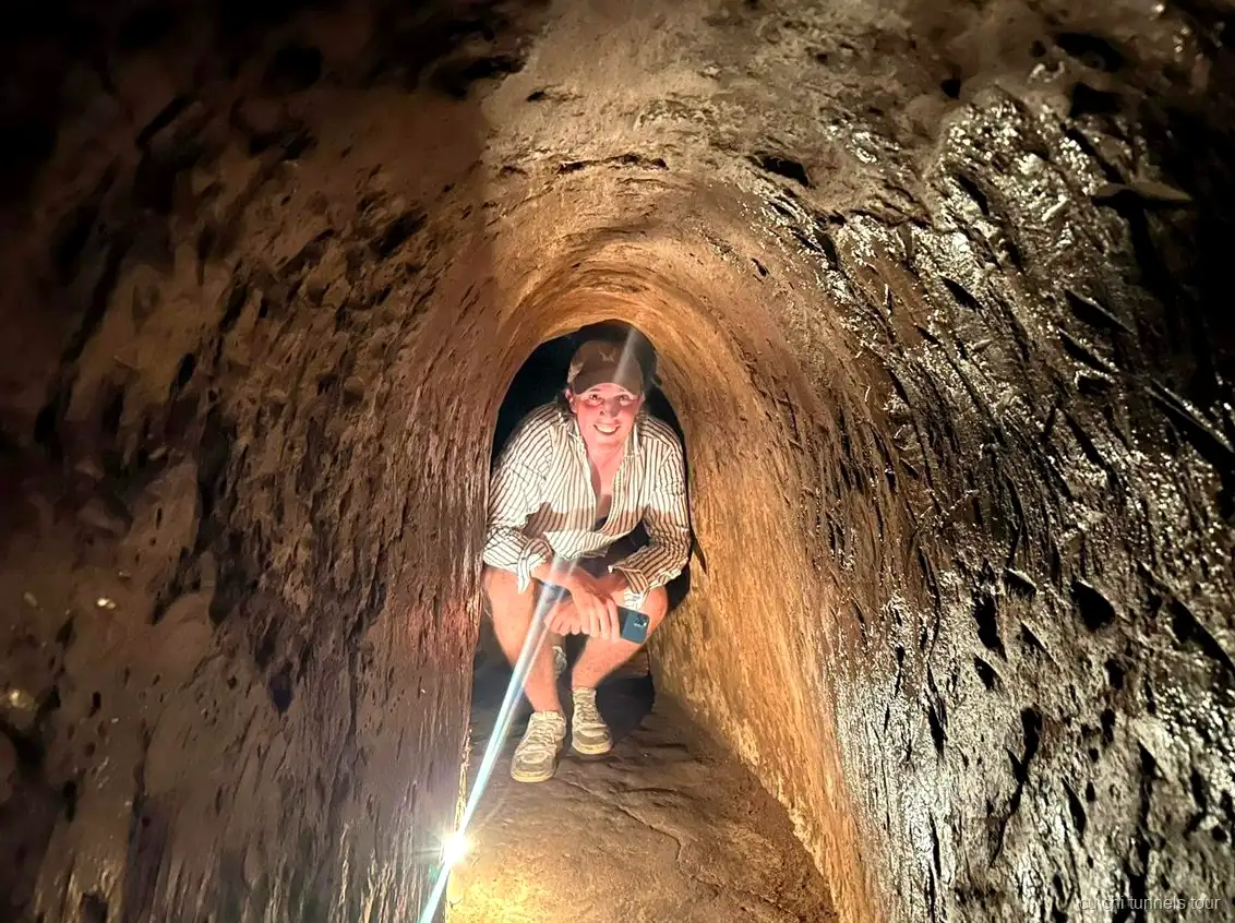 Visitors on a Cu Chi Tunnels tour walking the jungle trail near the tunnel entrances