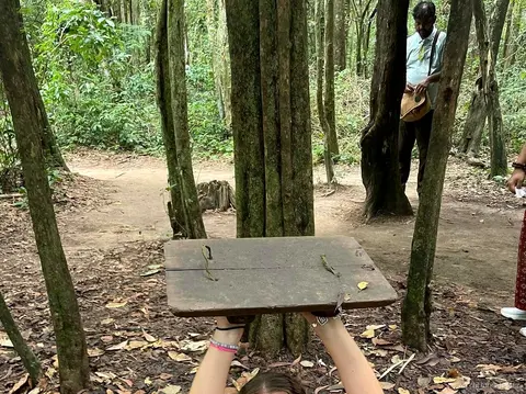Guide explaining the Cu Chi Tunnels network to a tour group